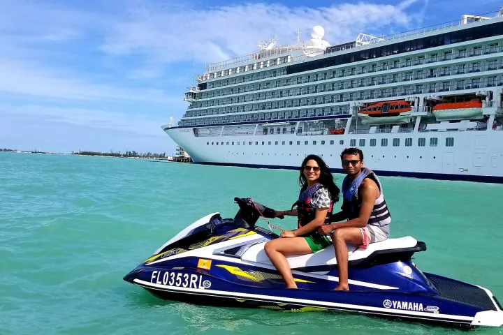 a person riding on the back of a boat in the water