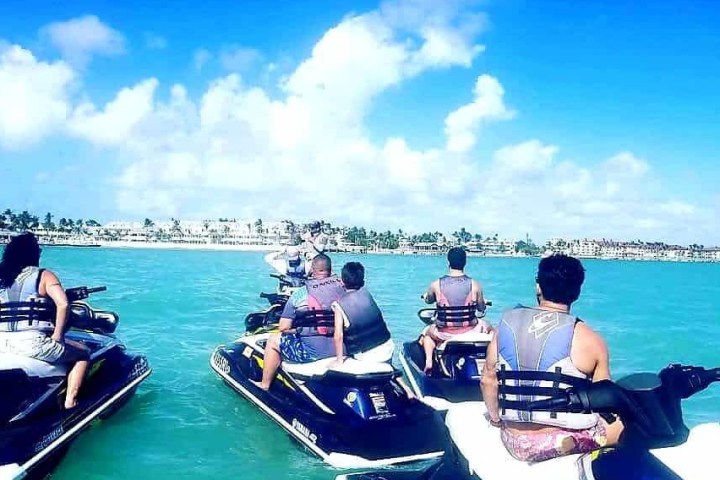 a group of people sitting in a boat on a body of water
