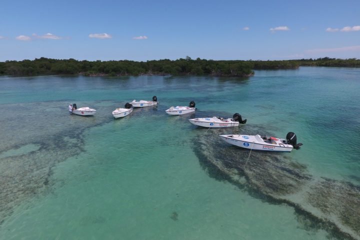 a group of people in a boat on a body of water