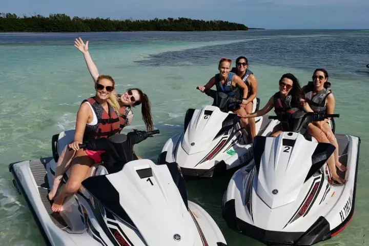 a group of people in a boat on a body of water