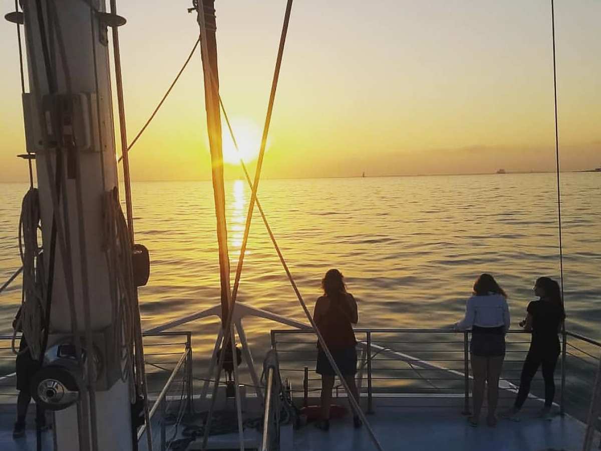 a group of people in a boat on a body of water