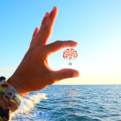 a man holding a frisbee in a body of water
