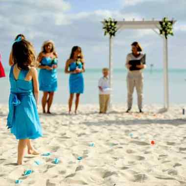 a group of people standing on top of a sandy beach