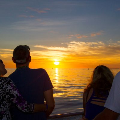a group of people standing next to a body of water