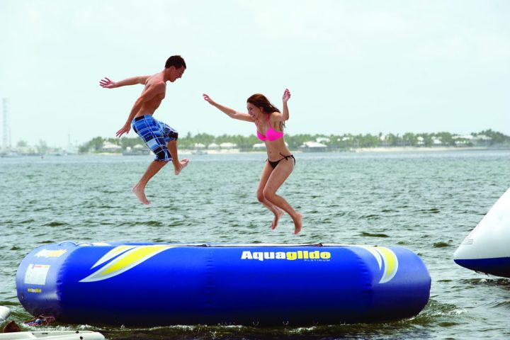 a group of people riding on the back of a boat in the water